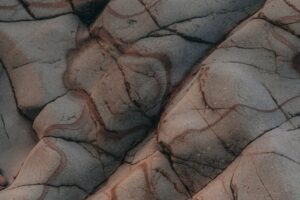 Building Machine Learned Models - Abstract rock texture with natural patterns and cracks, symbolizing complexity in machine learning models.