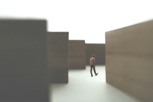 microsoft ediscovery indexing - Person navigating large abstract blocks, symbolizing challenges in encrypted content eDiscovery.